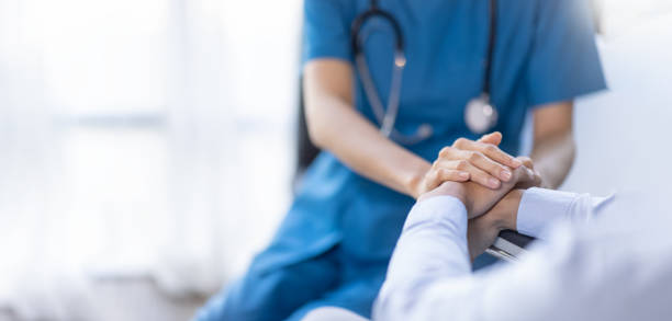 nurse holding a patient's hand